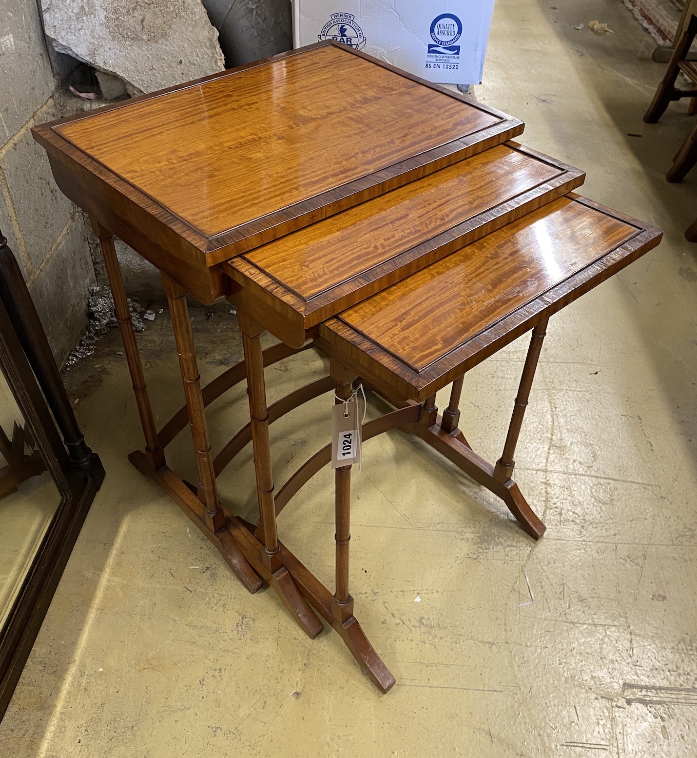 A nest of three rectangular rosewood banded satinwood tea tables, width 49cm, depth 38cm, height 60cm